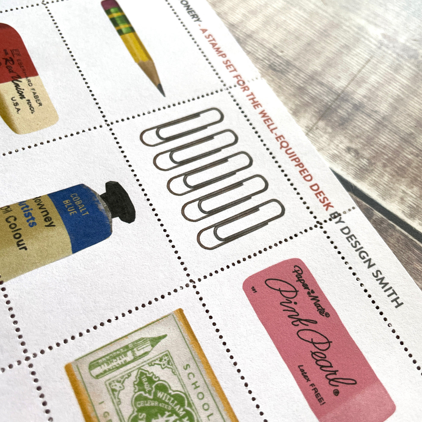 Sheet of decorative stamps illustrating stationery items including pens, brushes, and washi tape.
