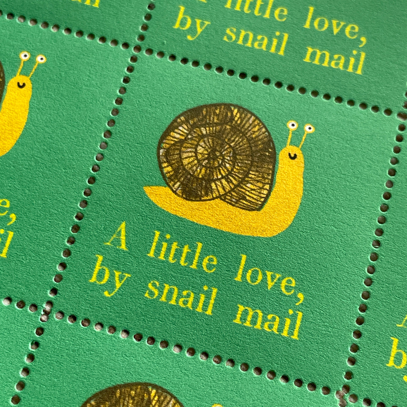 Sheet of thirty decorative stamps illustrating a snail with the phrase a little love by snail mail.