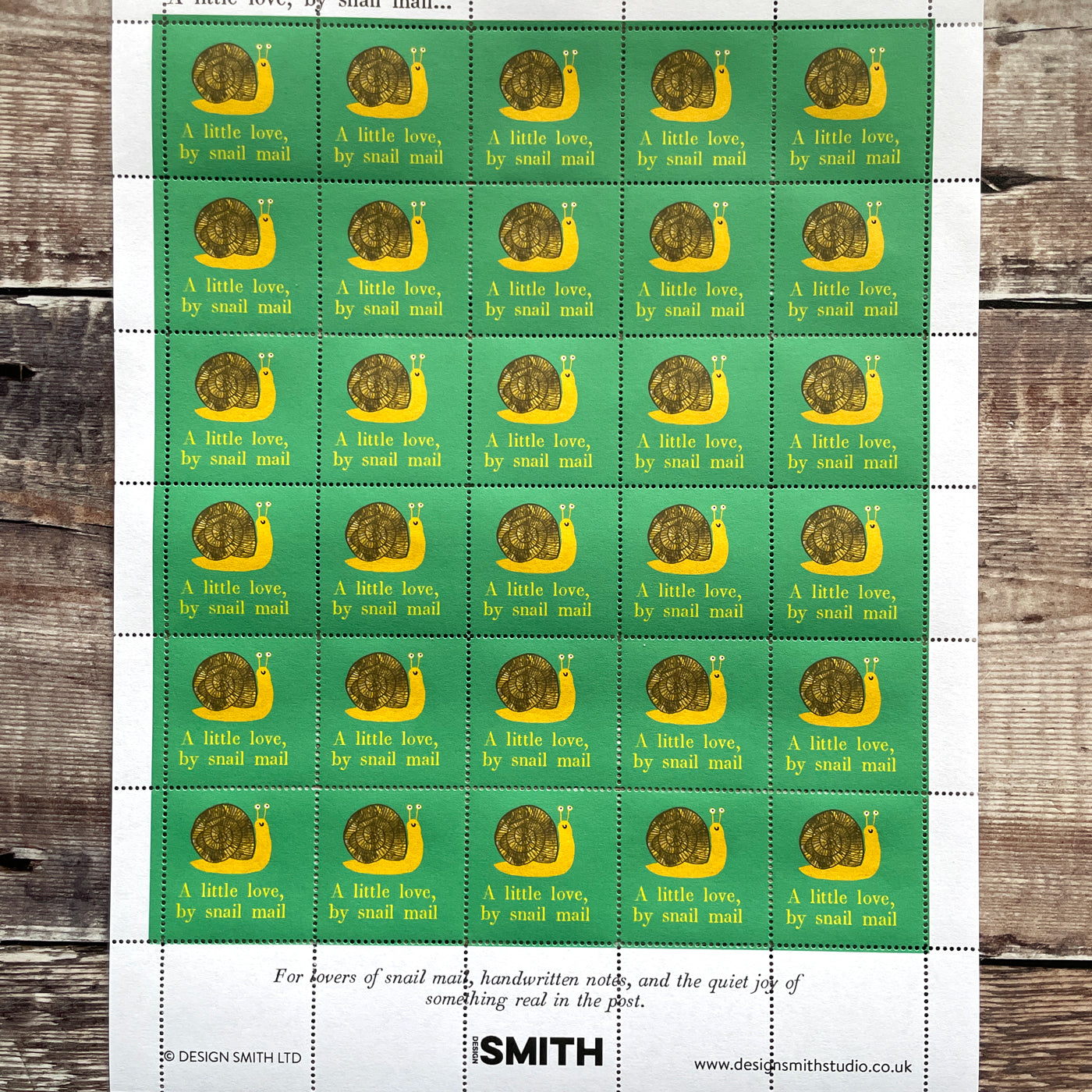 Sheet of thirty decorative stamps illustrating a snail with the phrase a little love by snail mail.