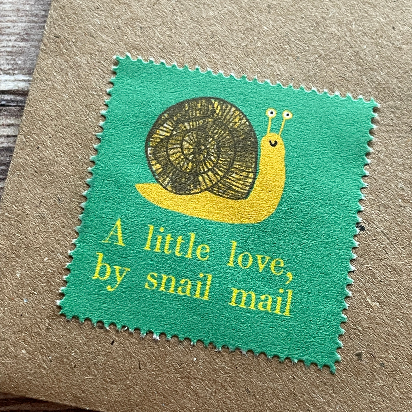 Sheet of thirty decorative stamps illustrating a snail with the phrase a little love by snail mail.