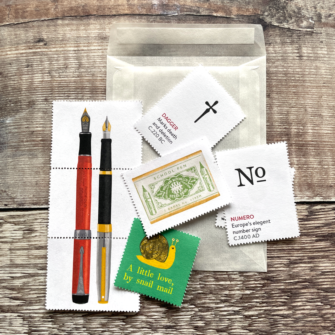 Small glassine envelope containing five decorative illustrated stamps.